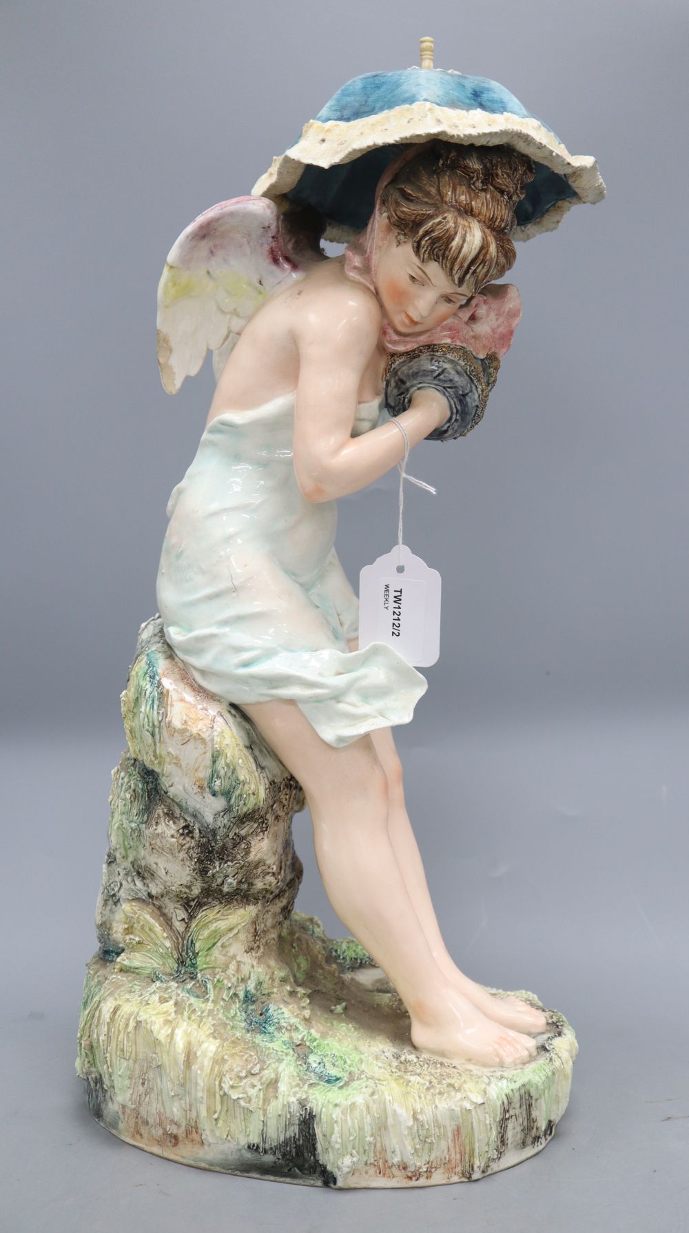 A Continental large pottery figure of a winged nymph,